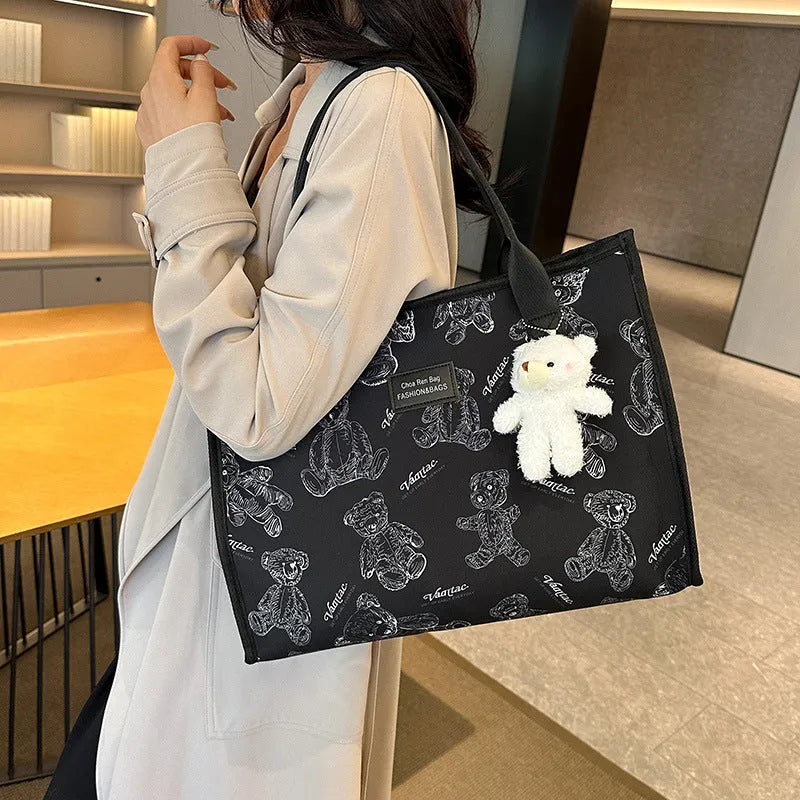 Women's black and white printed canvas tote bag with rhombus pattern showing large capacity and shoulder strap