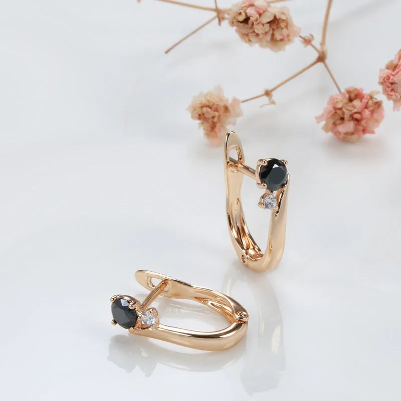 Gold geometric drop earrings with black agate stone styling