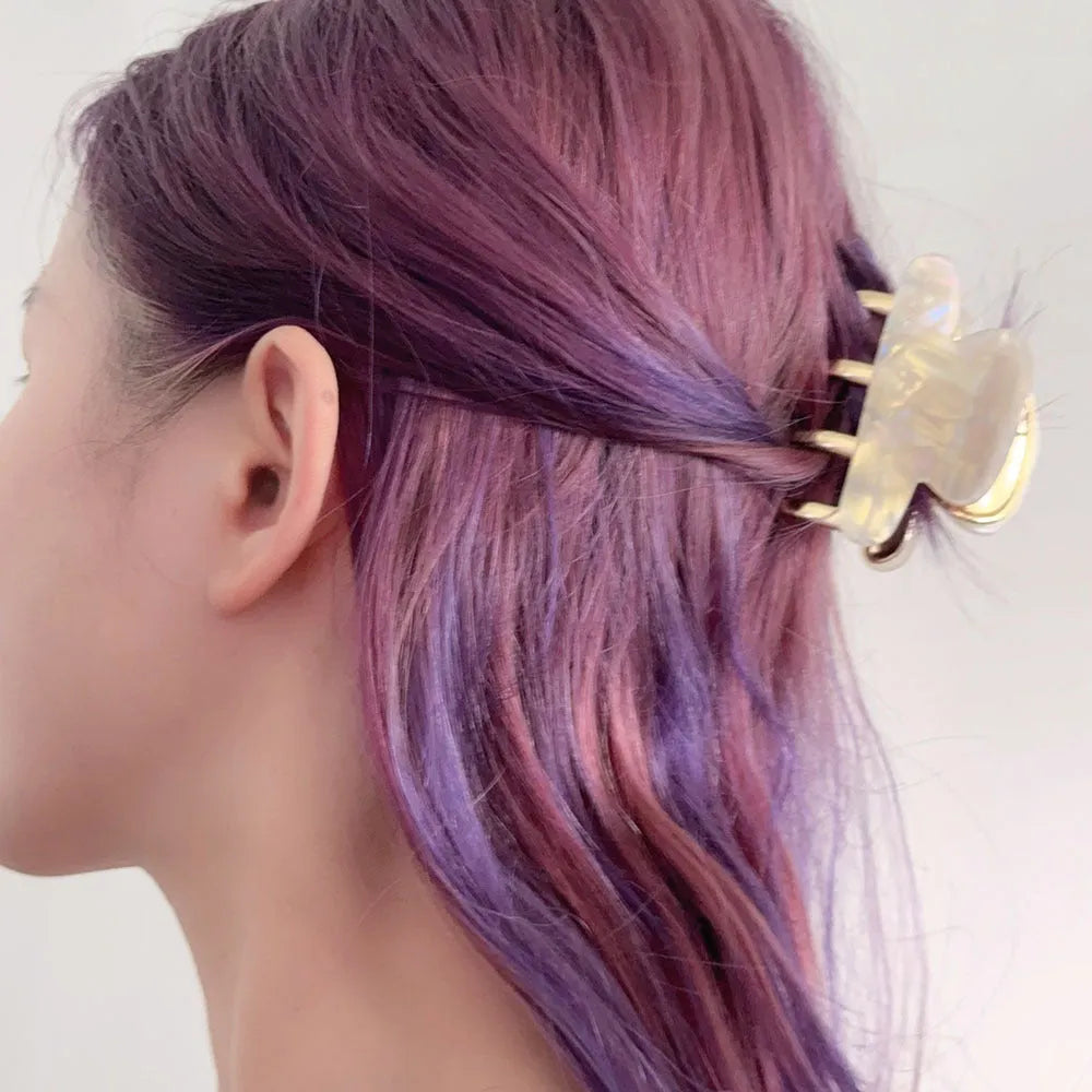 Retro acetate hair grip with metal clamp in medium size, showing irregular pattern on surface