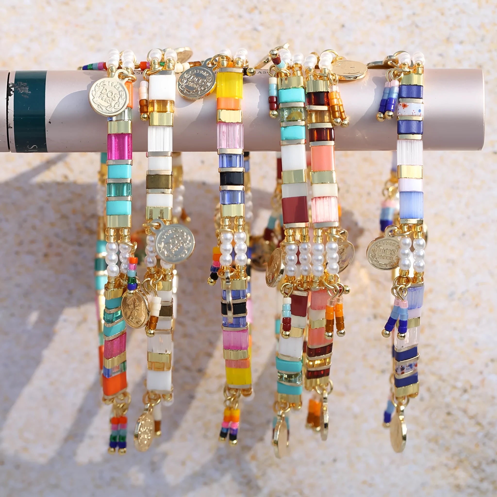 Women's imitation pearl beaded bracelet showing six pearl-lift colour variations with manual processing