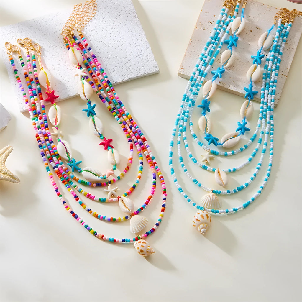 Blue and coloured women's summer necklace set with starfish, shell, and conch bead pendants on beaded chains