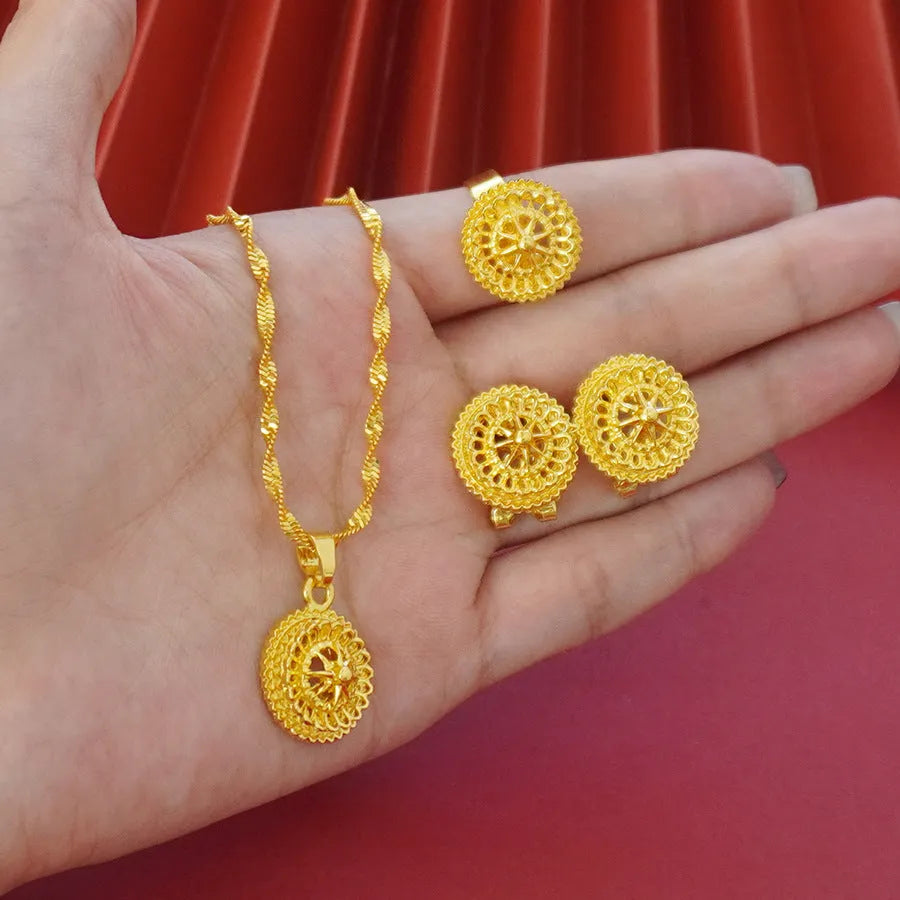 Gold electroplated three-piece jewellery set with floral designs, water wave chain necklace, matching earrings and ring
