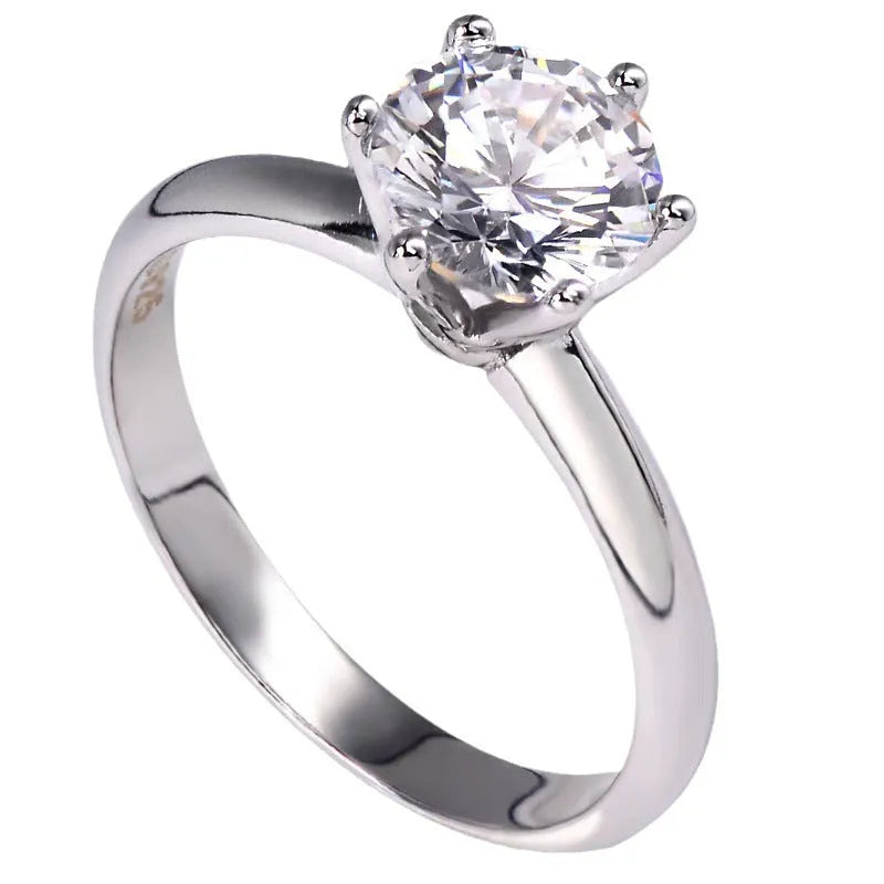 White gold plated six-claw zircon ring with geometric design on a white copper band.