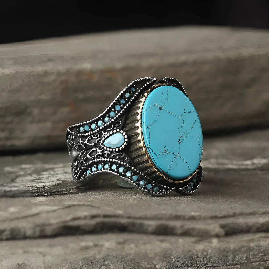 Men's antique silver alloy ring with round band and central turquoise stone on finger
