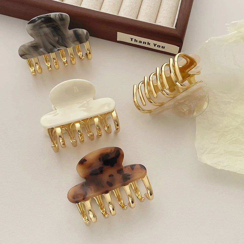 Retro acetate hair grip with metal clamp in medium size, showing irregular pattern on surface