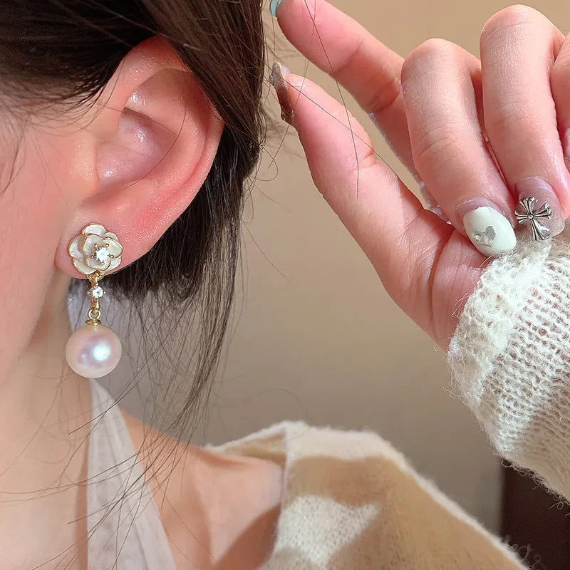 A pair of women's alloy stud earrings shaped like a detailed camellia flower in a 'Camellia' colour.