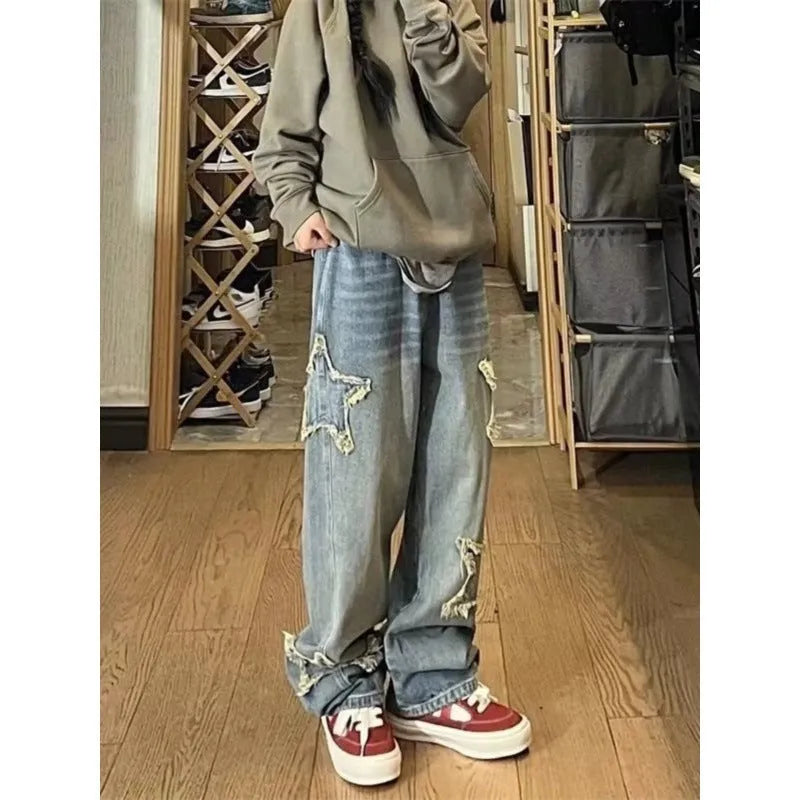 Blue high waist straight leg women's jeans on a hanger, showing the trouser length and front button detail.