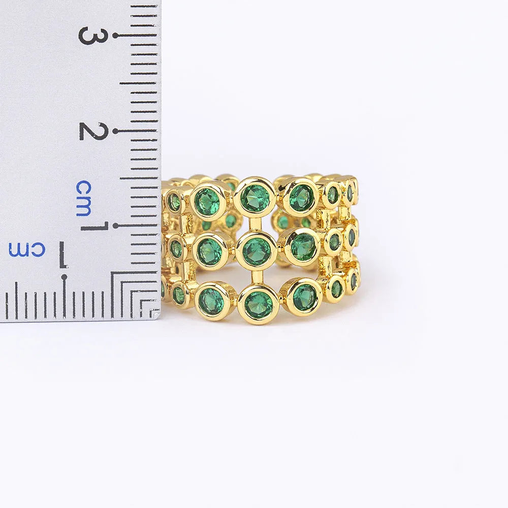 Copper ring with gold plating and green zircon stones in wide band design