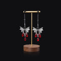 Silver bat-shaped nipple clamp with ruby detail and adjustable tension mechanism