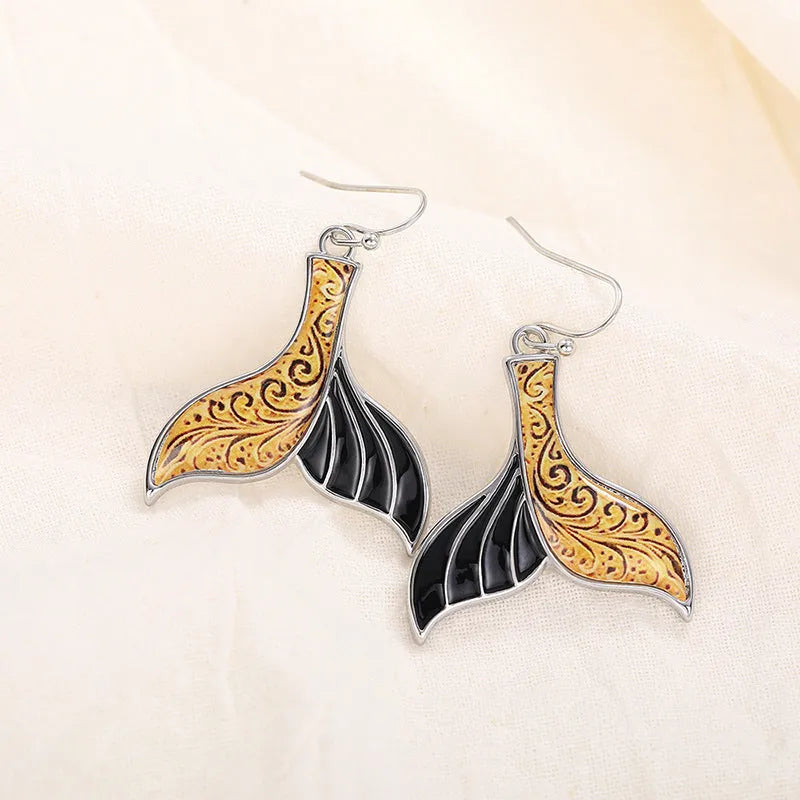 Women's white gold colour fishtail earrings with whale charm detail on alloy