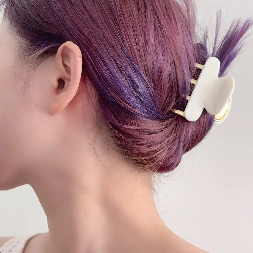 Retro acetate hair grip with metal clamp in medium size, showing irregular pattern on surface