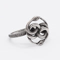A titanium steel double snake ring in a steel colour retro style, shown on a finger.