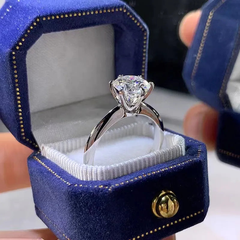 White gold plated six-claw zircon ring with geometric design on a white copper band.