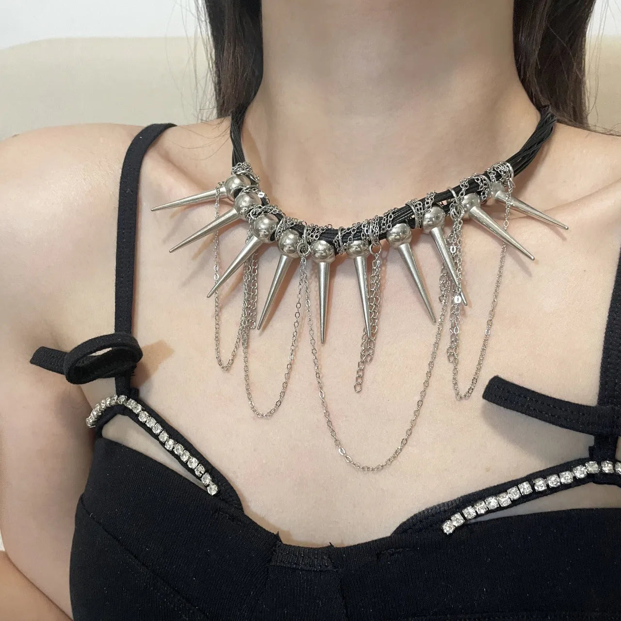 Women's casual leather necklace with electroplated round beads, a winding tassel, and point rivet details.