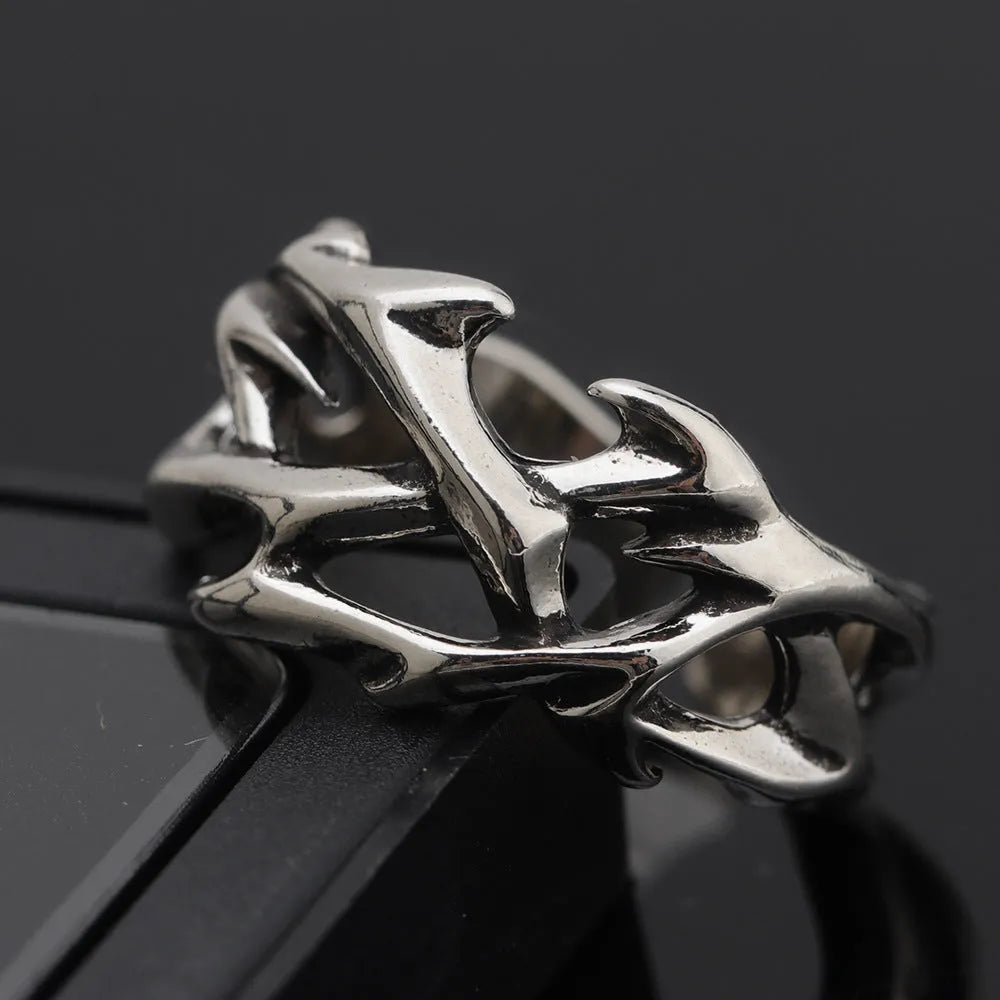 Copper geometric thorn flower ring with adjustable band on a grey background.