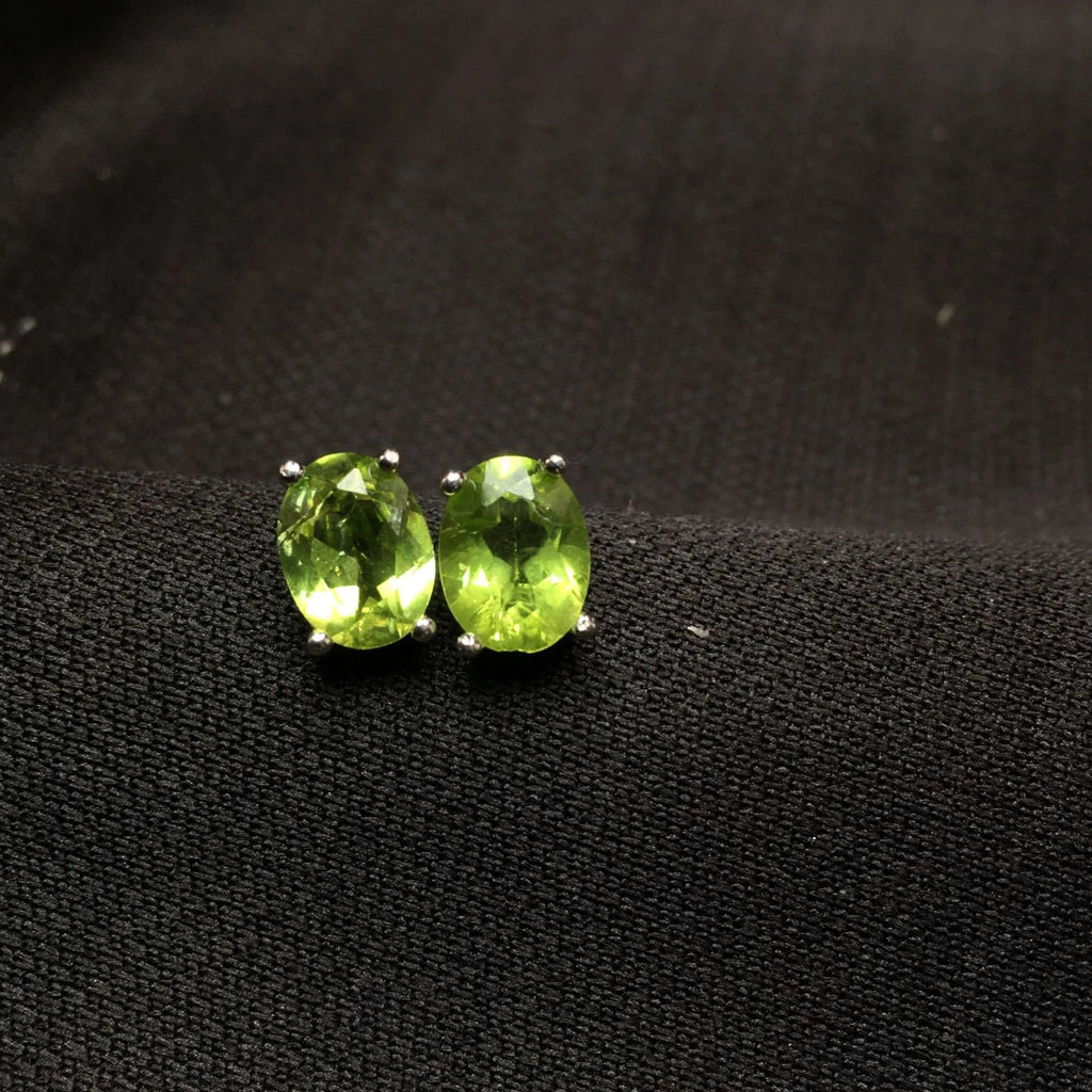 Grass green olivine stud earrings with S925 silver setting and geometric oval stone.