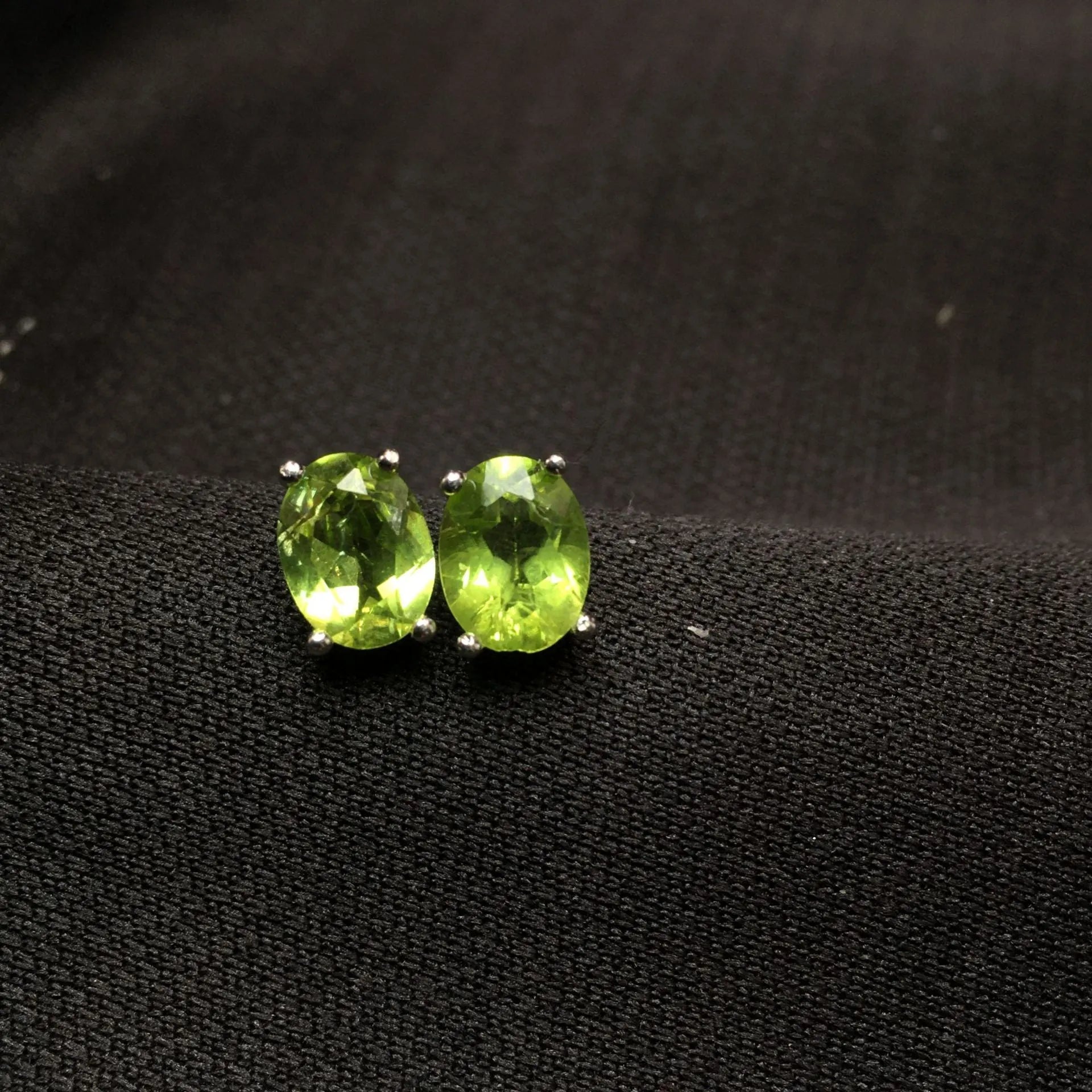 Grass green olivine stud earrings with S925 silver setting and geometric oval stone.