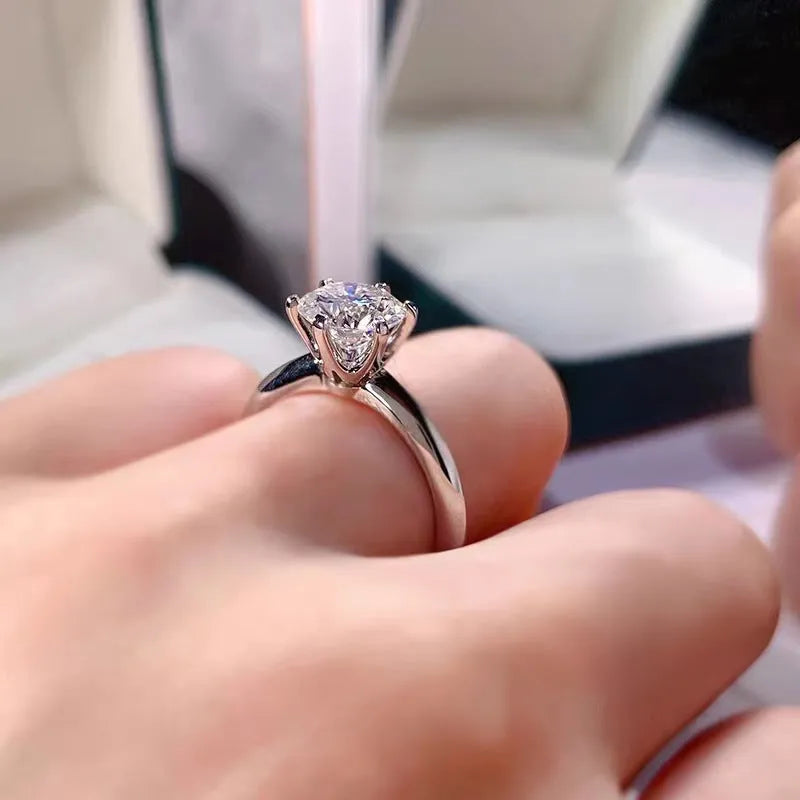 White gold plated six-claw zircon ring with geometric design on a white copper band.