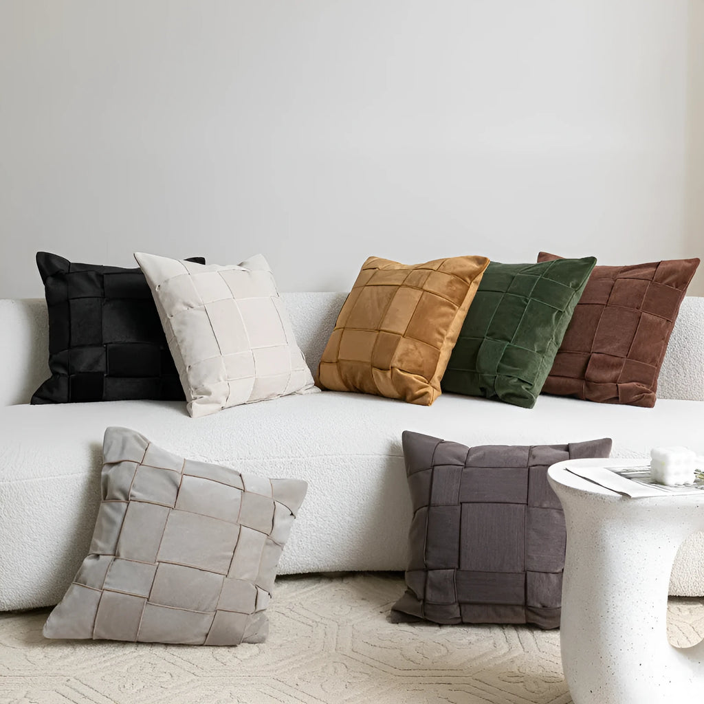 Square 50x50 cm chenille woven pillow cushion in beige colour on a grey sofa.