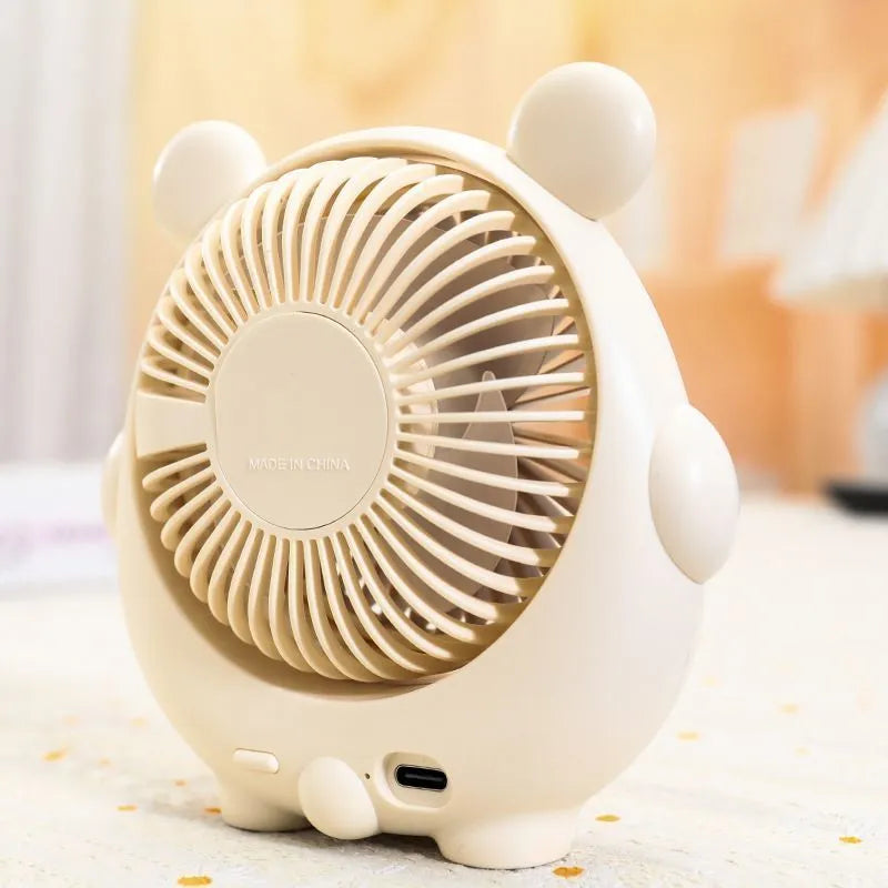 Cute dog-themed USB desktop electric fan in one of six colour options on a desk.