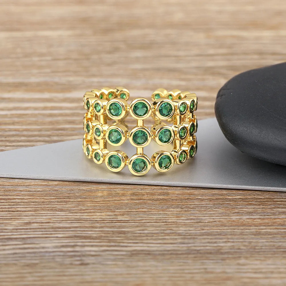 Copper ring with gold plating and green zircon stones in wide band design