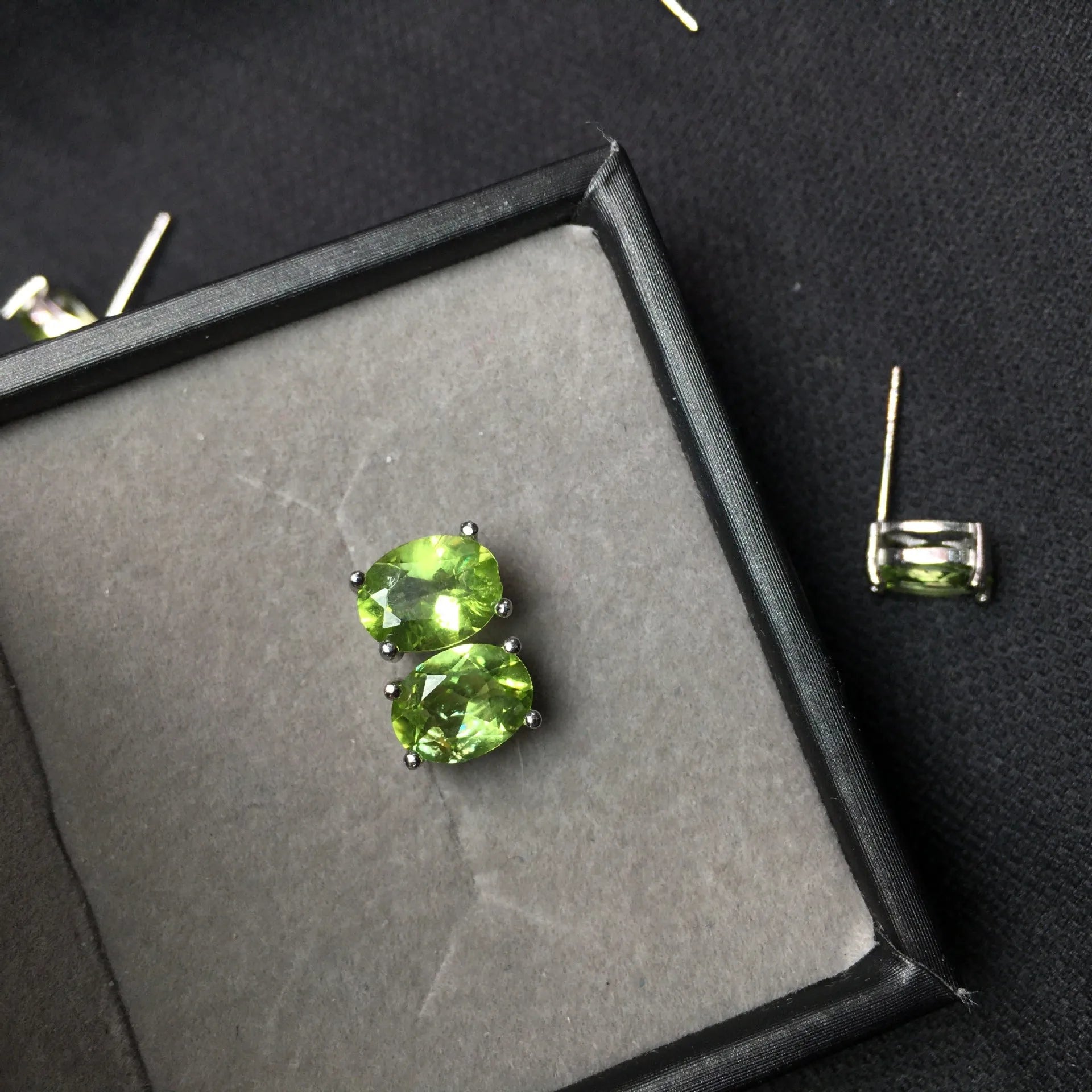 Grass green olivine stud earrings with S925 silver setting and geometric oval stone.