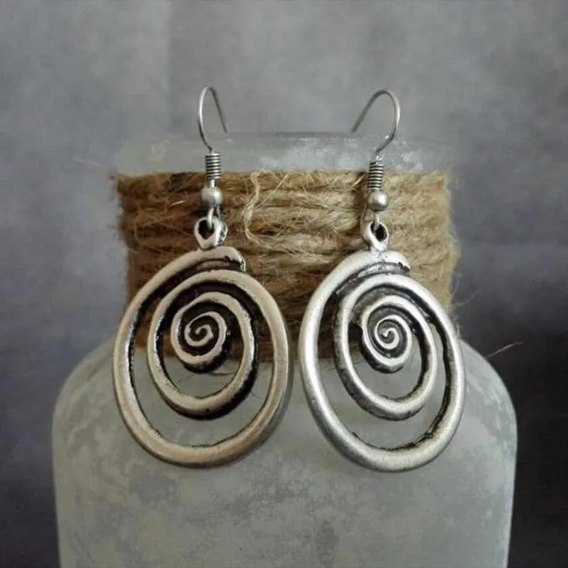 Silver alloy geometric spiral earrings with a distressed finish, measuring 2.6cm by 5cm.
