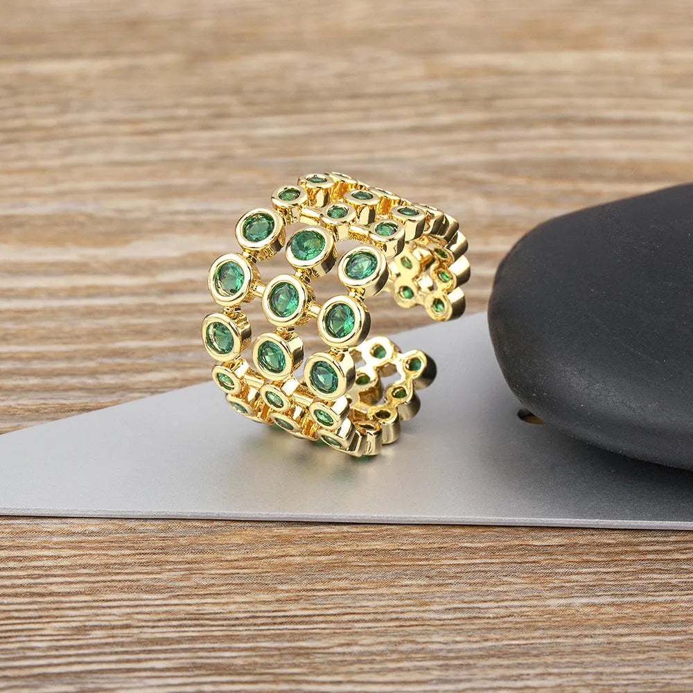 Copper ring with gold plating and green zircon stones in wide band design