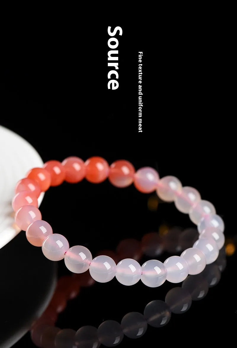 Natural gradient Yanyuan agate bracelet with smooth geometric beads on a wrist.