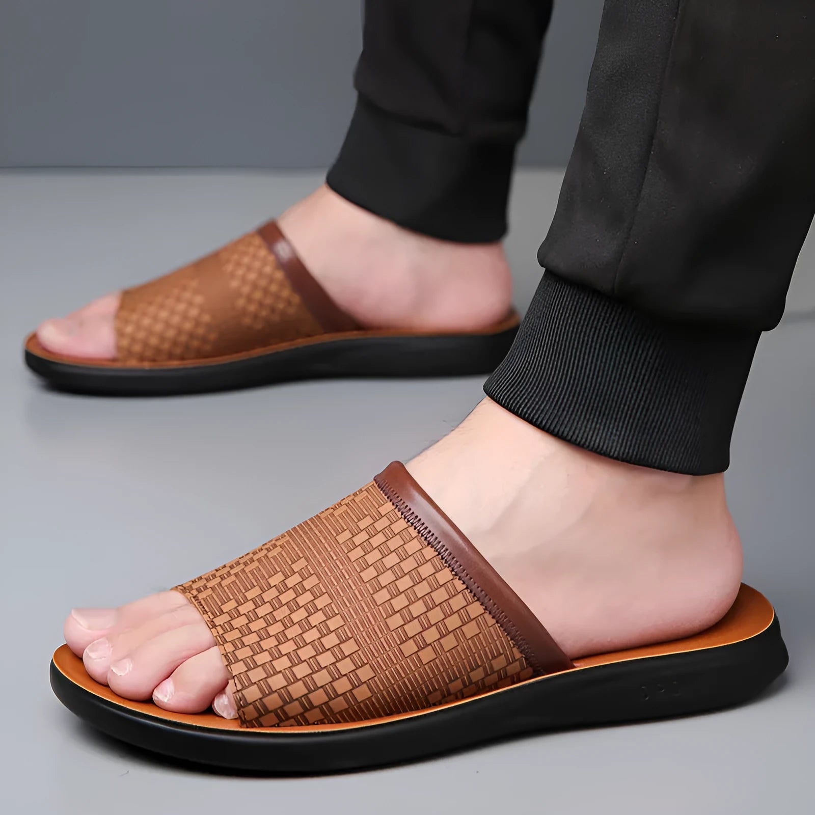 Men's breathable PU leather slippers in black with flat heel and round toe, side view