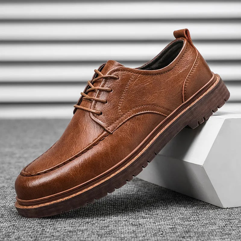 Men's brown leather casual shoes with round toe and flat rubber sole on a white background