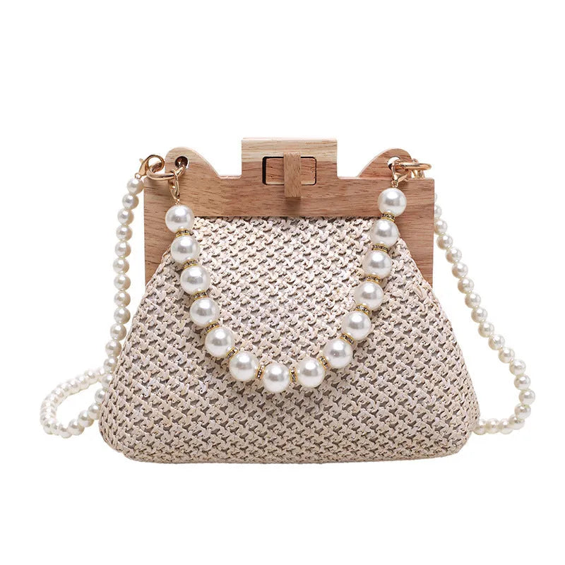 Women's woven straw shoulder bag with pearl chain strap and zippered interior pockets in beige, black, or khaki