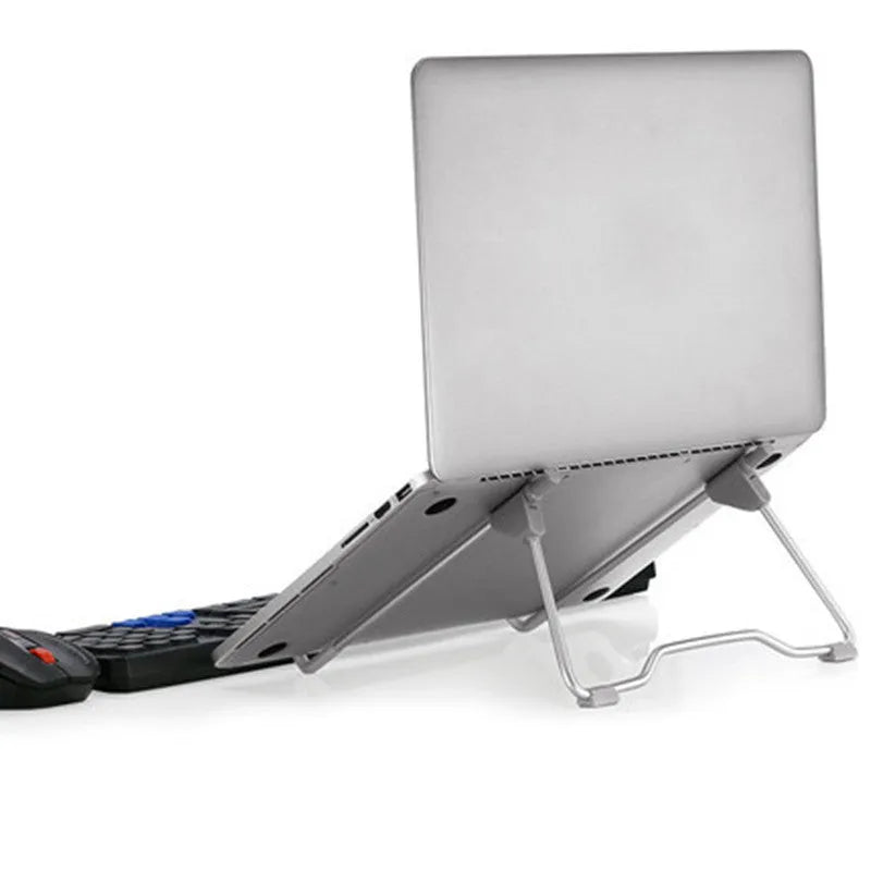 Grey aluminium alloy mobile phone and laptop stand with adjustable angles on a desk