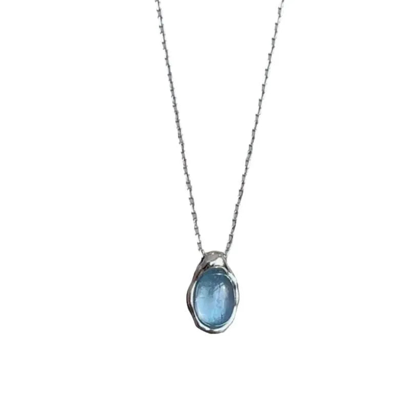 Navy blue water drop geometric pendant necklace with cross chain design on white background