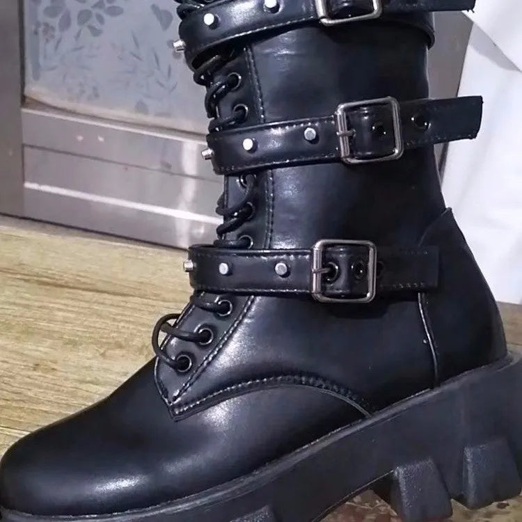 Women's black mid-calf knight boots with a metal buckle and side zipper on a chunky sole.