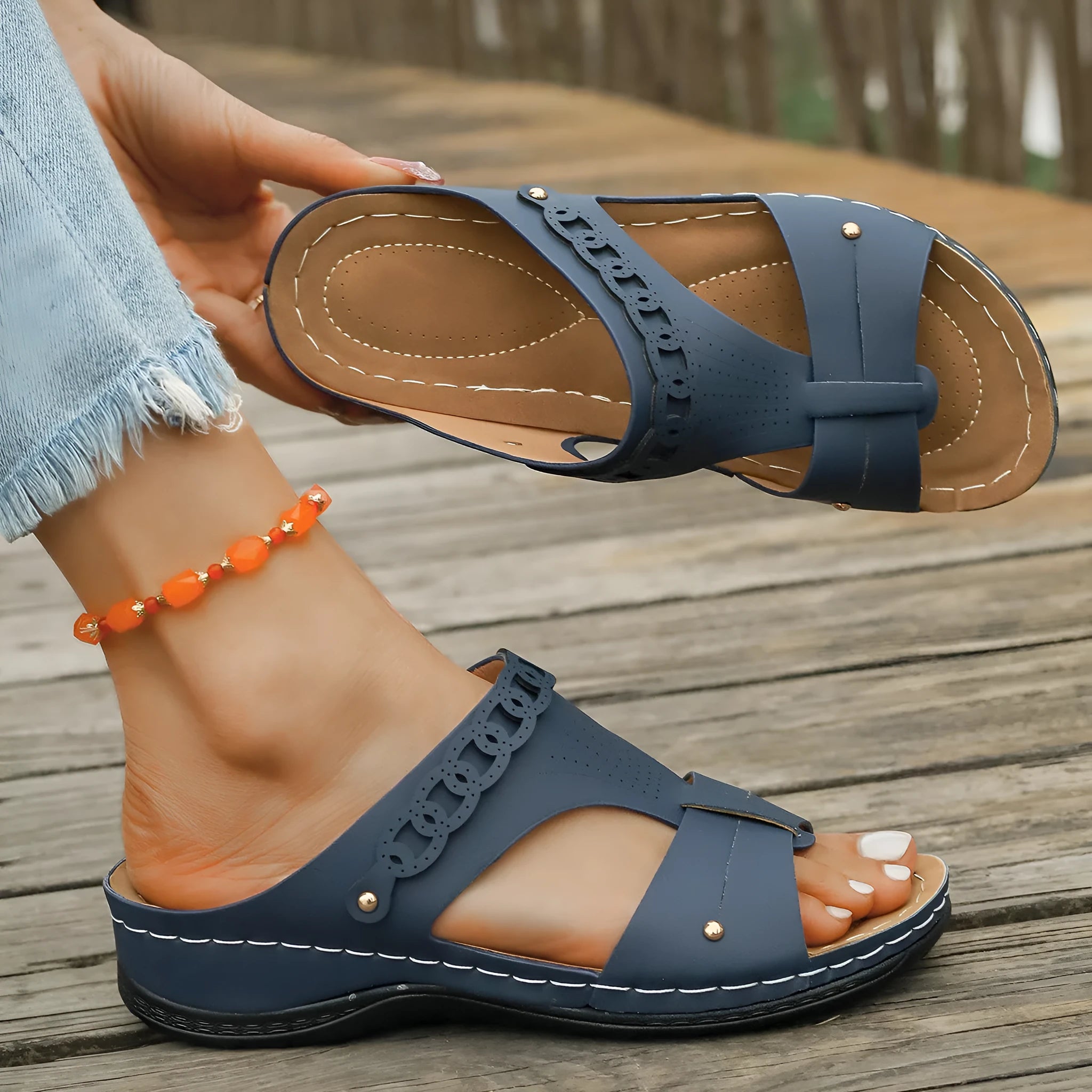 Casual slope heel roman style slippers in blue with fish mouth toe design and rubber sole.