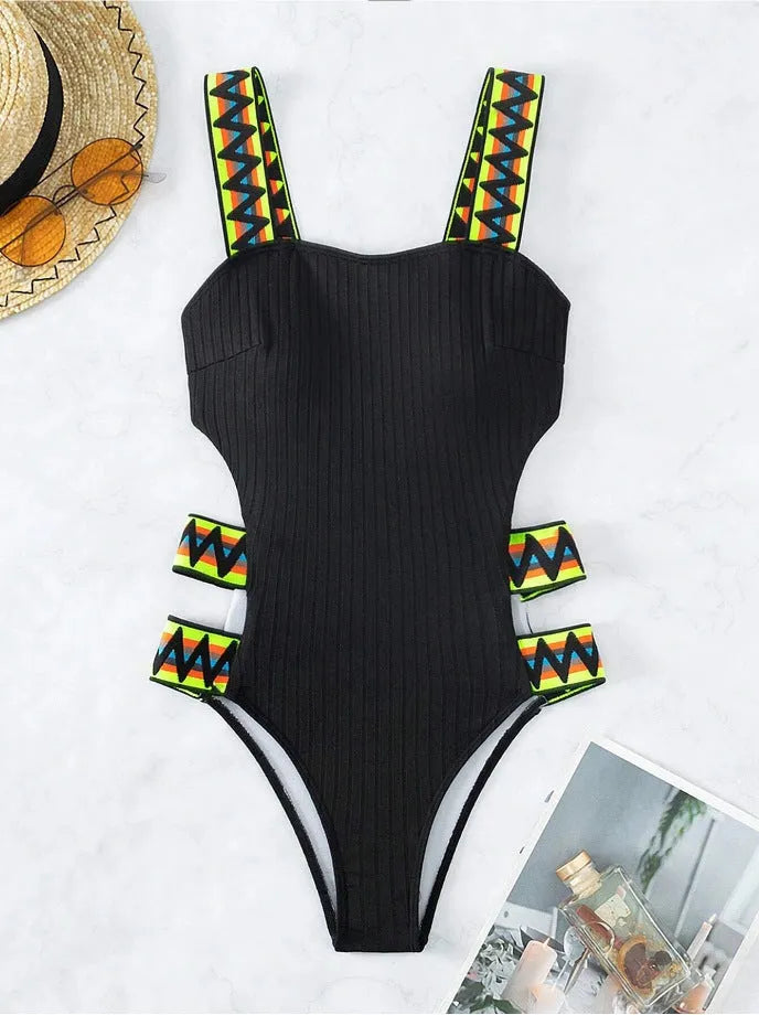 Solid black and orange women's one-piece polyester swimsuit bikini on a white background.