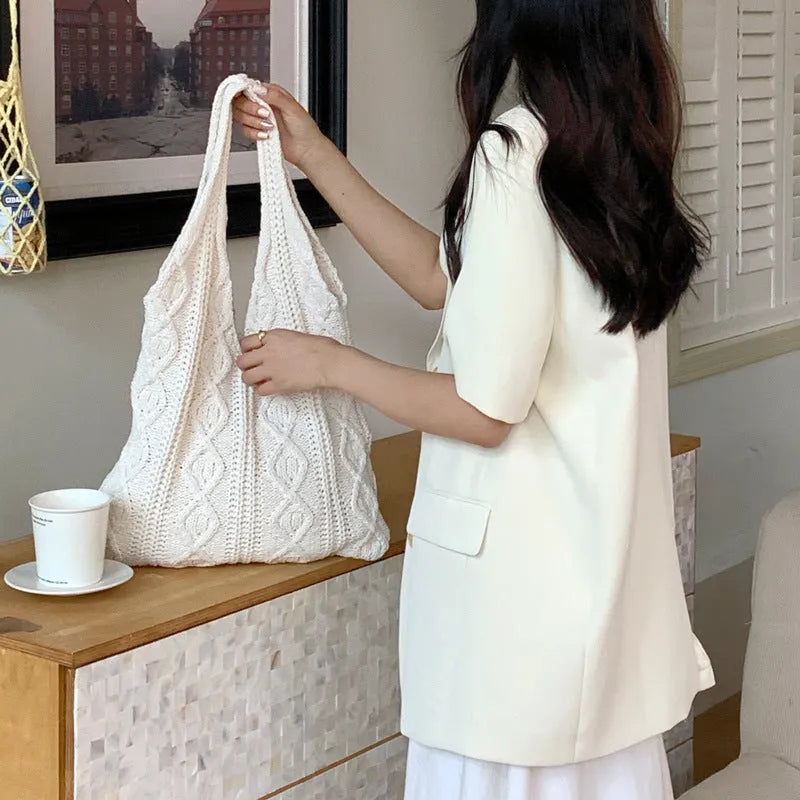 Retro hollow knitted polyester shoulder bag measuring 55cm by 37cm in solid colour with double straps