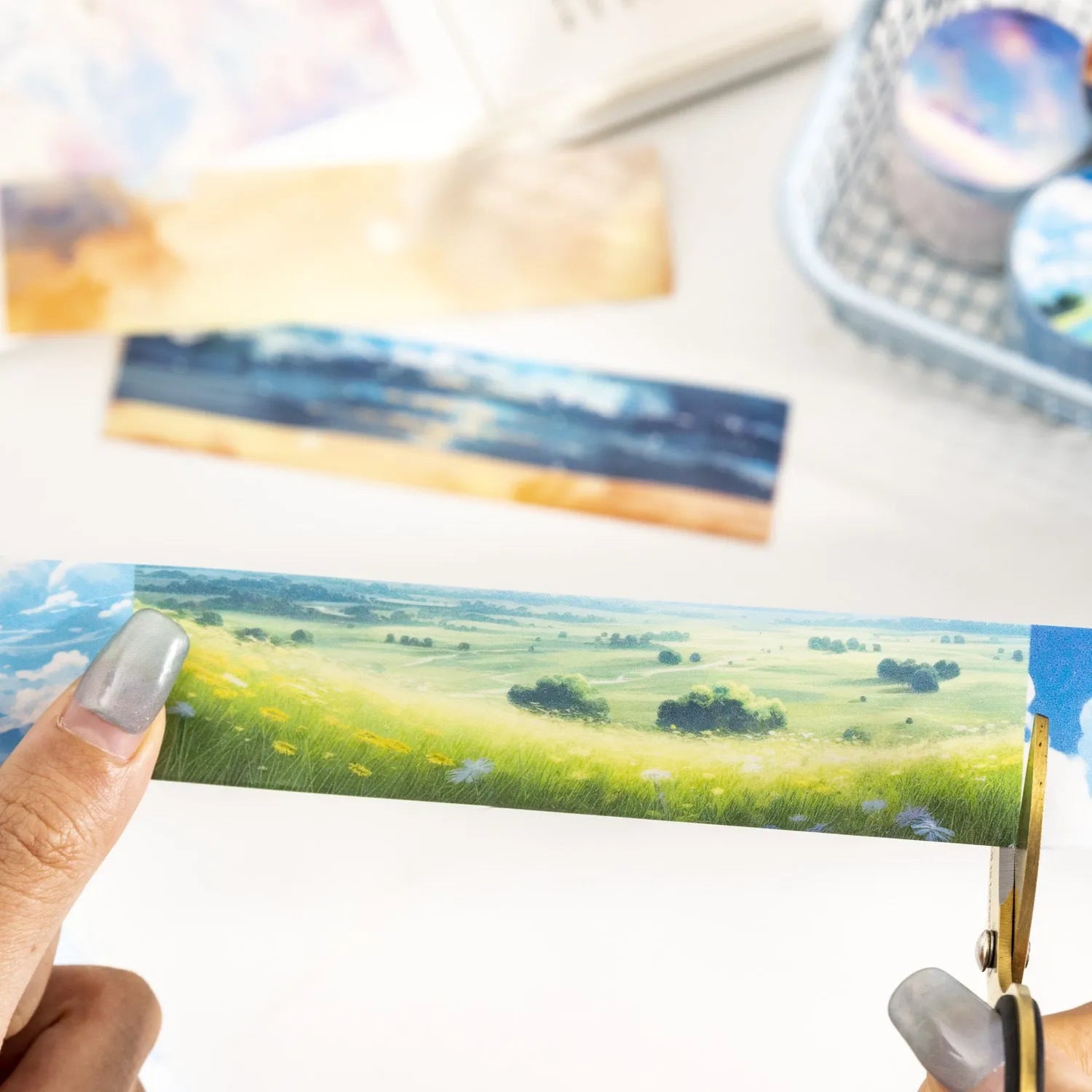 Roll of Japanese paper decorative tape with sky theme patterns including clouds, sun, moon, and nebula.