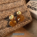 Three pairs of geometric alloy earrings with electroplated finishes in irregular amber, wafer round, and water drop tassel styles