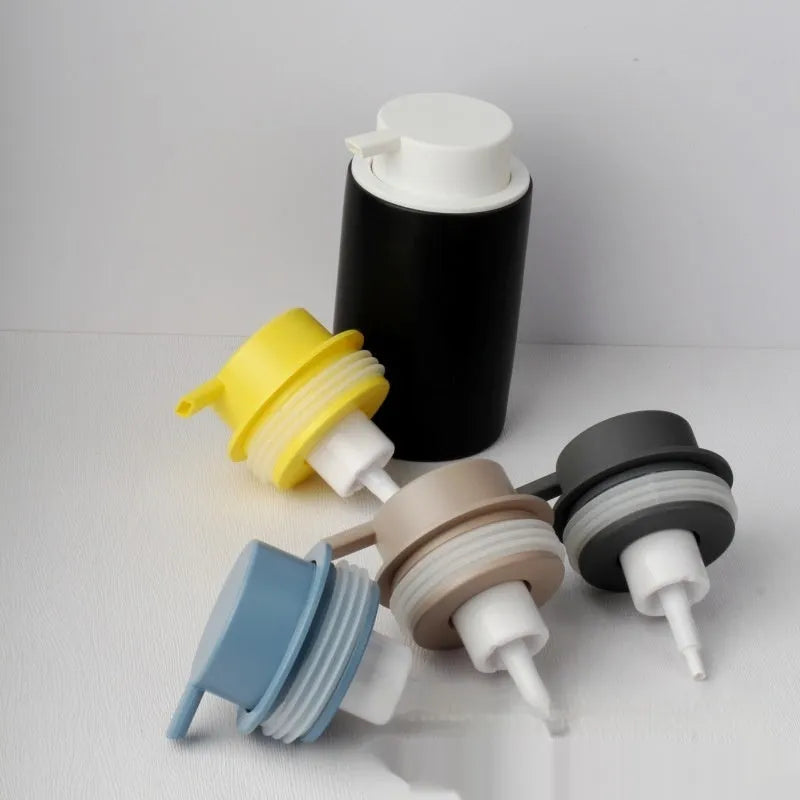 Foam pump bottle dispenser with large metallic pump head for facial cleanser.