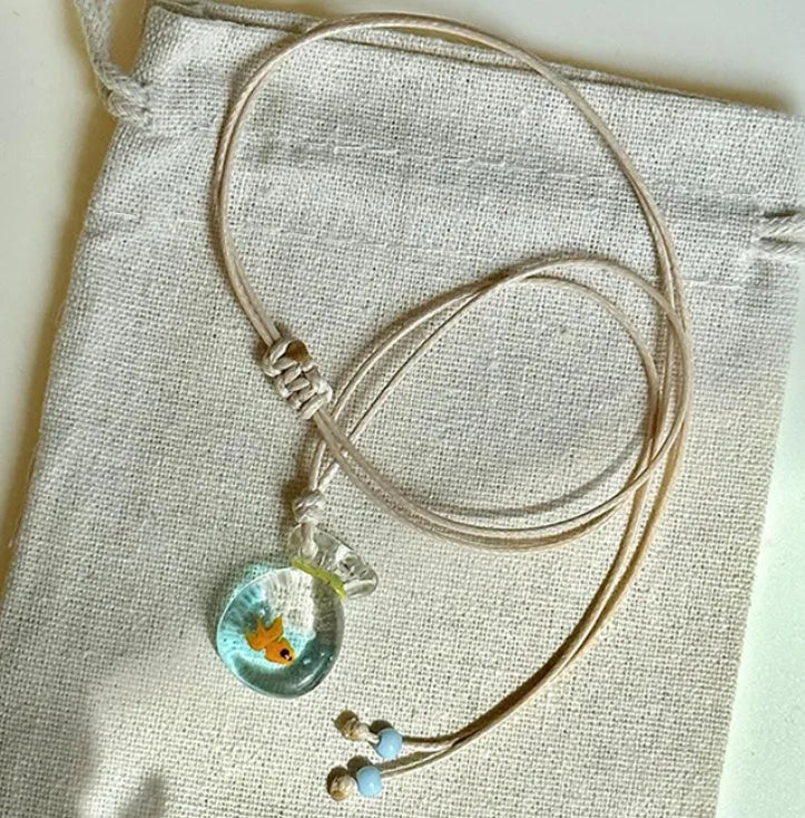 Women's joker pendant necklace with coloured glaze ornament on a cotton and linen clavicle chain.