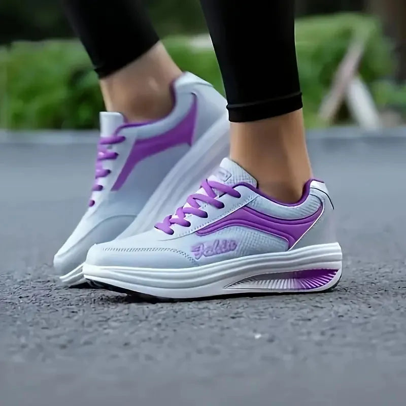 Women's grey and black travel sports shoes with a middle heel, shown from the side.