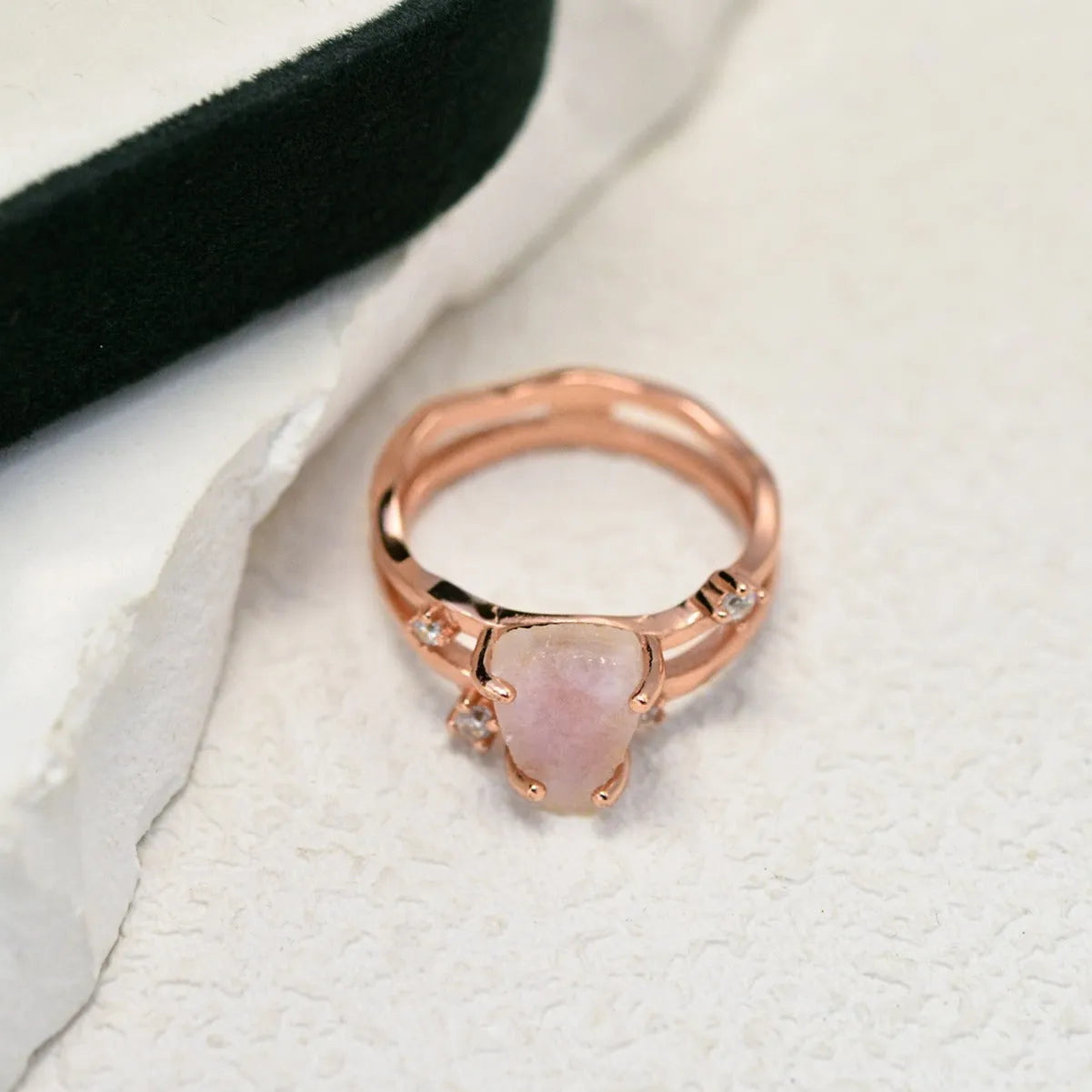 S925 silver ring with an irregular triangle shape holding a moonstone, shown in a rose gold electroplated finish.