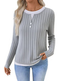 Women's black fake two-piece pullover sweater with round neck and button detail on concave stripe fabric