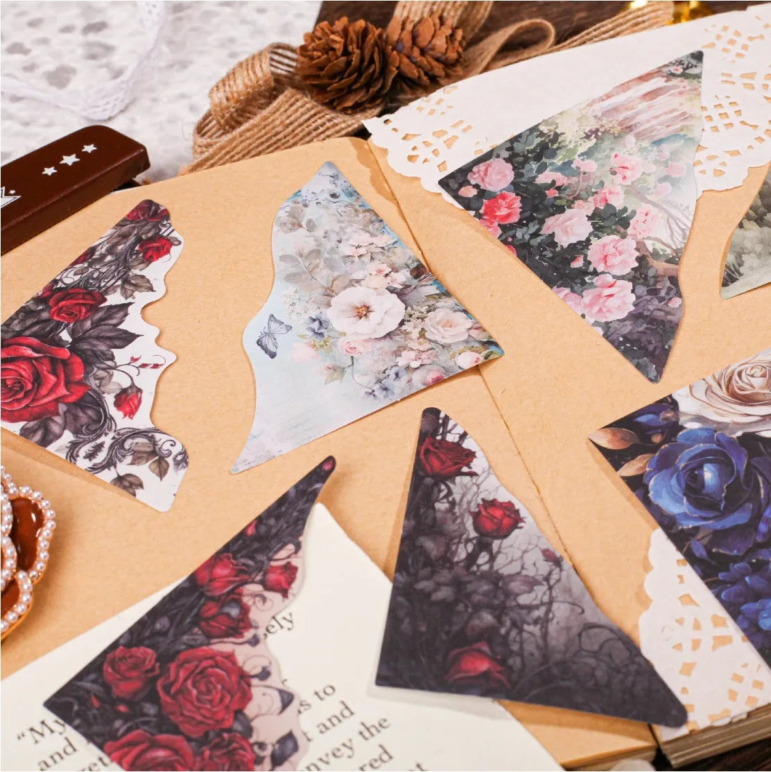 Decorative notebook set showing artistic covers in spring vine, pink plum, red rose, blue, green field, and purple dew colours.