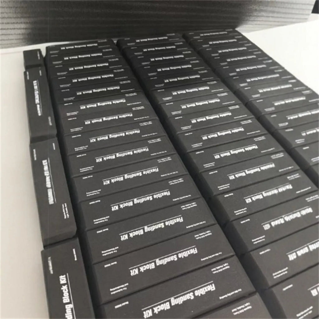 Seven black EVA frosted metal building blocks arranged together