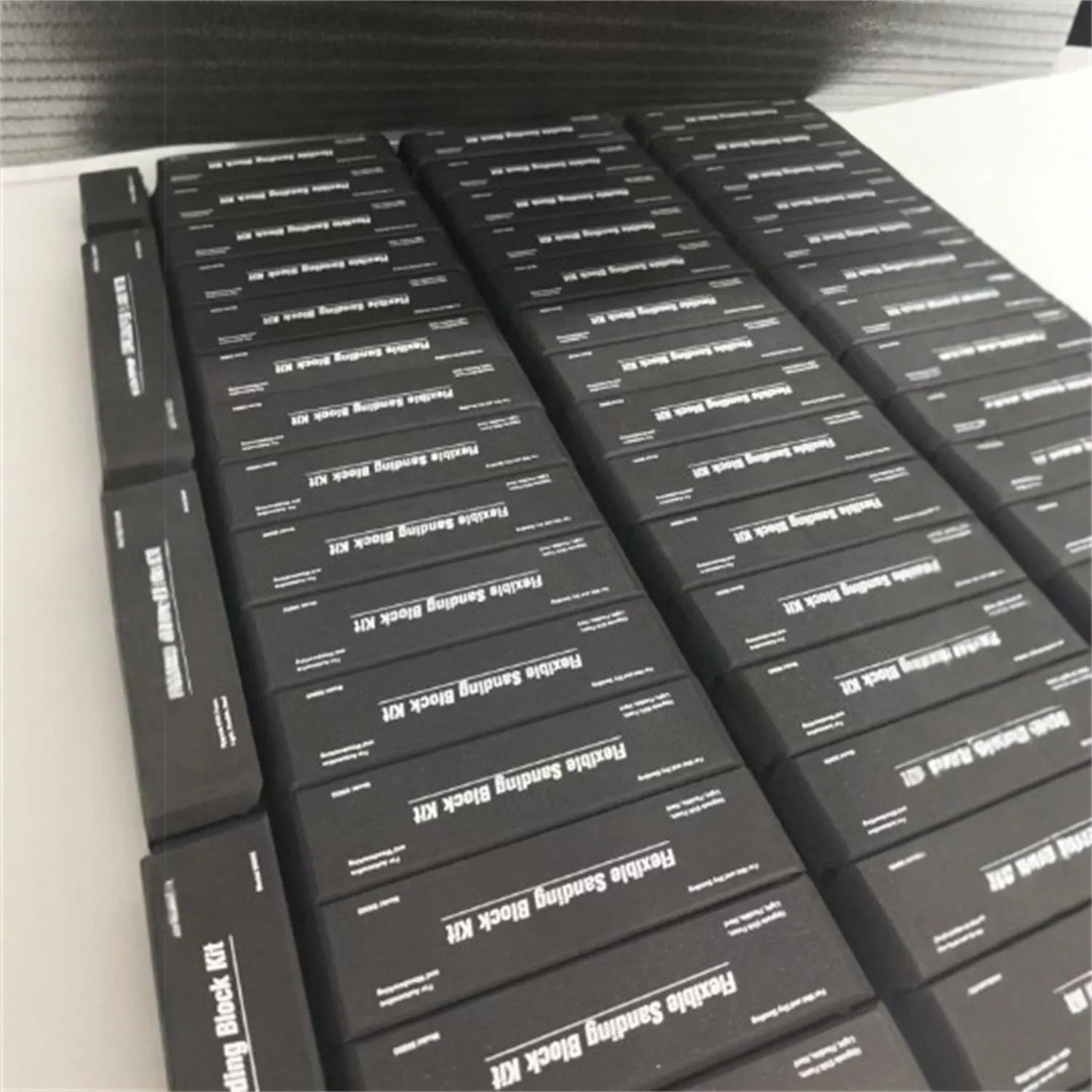 Seven black EVA frosted metal building blocks arranged together