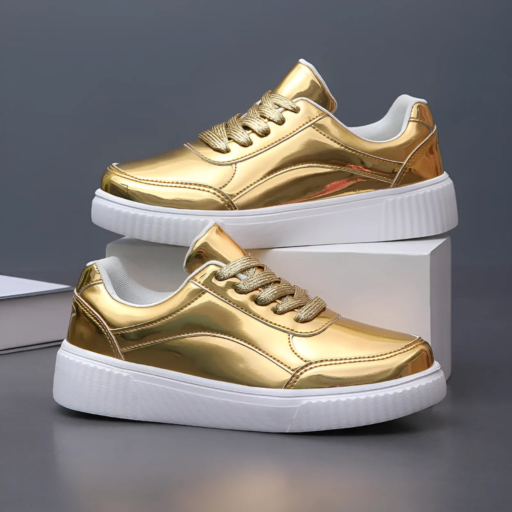 Gold sequinned platform sneakers with thick sole and round toe on a neutral background.