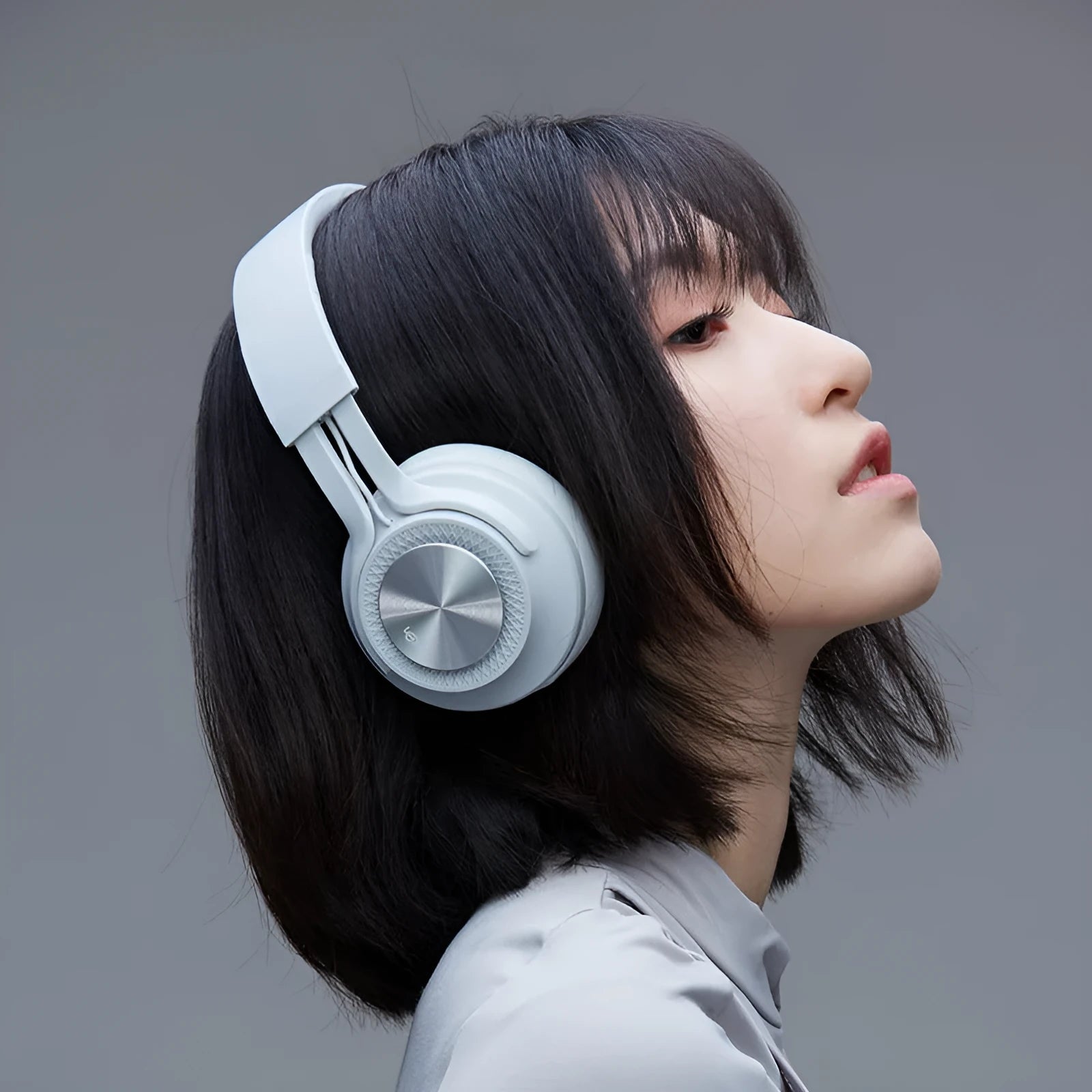 Sports wireless Bluetooth headset in red, grey, green, or black colours showing on-ear design.